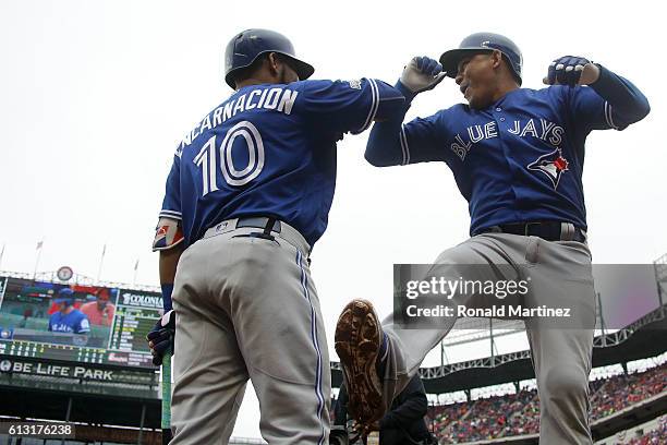 Ezequiel Carrera of the Toronto Blue Jays celebrates with Edwin Encarnacion after hitting a solo home run against the Texas Rangers in the fifth...