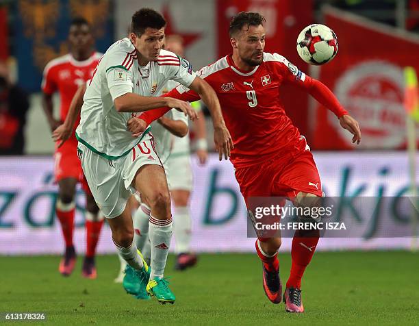 Hungary's Richard Guzmics vies with Swiss's Haris Seferovic during a WC 2018 football qualification match Hungary v Switzerland in Budapest on...