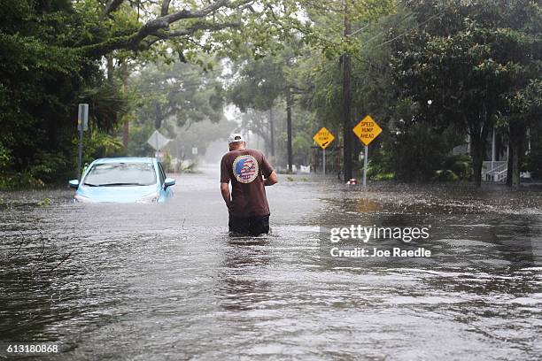 Paul walks through a flooded street as Hurricane Matthew passes through the area on October 7, 2016 in St Augustine, Florida. Florida, Georgia, South...