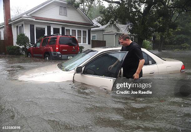 Rob Birch checks on his car which floated out of his drive way as Hurricane Matthew passes through the area on October 7, 2016 in St Augustine,...