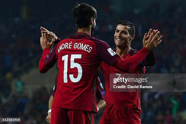 Cristiano Ronaldo of Portugal celebrates with his team mate Andre Gomes after scoring his team's fourth goal during the FIFA 2018 World Cup Qualifier...