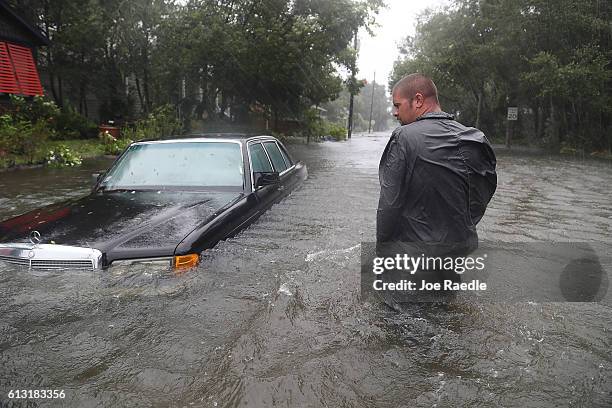 Nick Lomasney walks through heavy wind and a flooded street as Hurricane Matthew passes through the area on October 7, 2016 in St Augustine, Florida....