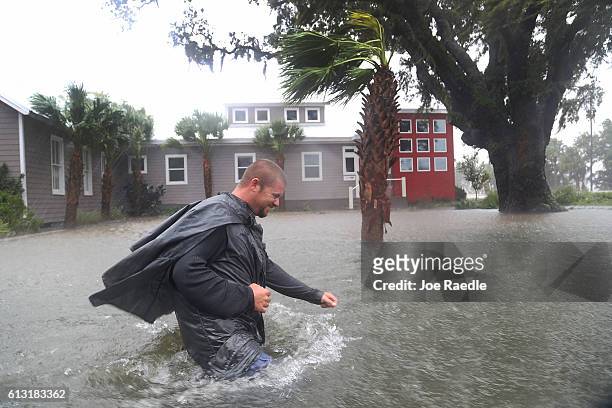 Nick Lomasney walks through heavy wind and a flooded street as Hurricane Matthew passes through the area on October 7, 2016 in St Augustine, Florida....