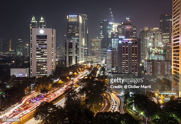 heavy traffic on jalan sudirman in jakarta at night - newly industrialized country stock pictures, royalty-free photos & images