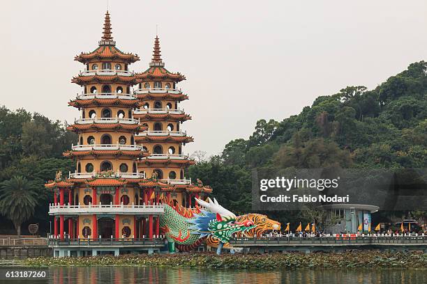 tourists at dragon and tiger pagodas at lotus pond, kaohsiung, taiwan - tiger pagoda stock pictures, royalty-free photos & images