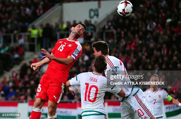 Hungary's Zoltan Gera , Richard Guzmics and midfielder, captain Balazs Dzsudzsak and Switzerland's Renato Steffen vie prior to their third score...