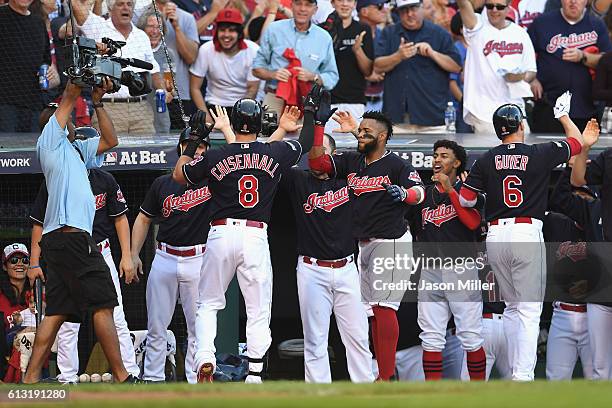 Lonnie Chisenhall of the Cleveland Indians celebrates with teammates at the dugout after hitting a three-run home run in the second inning against...