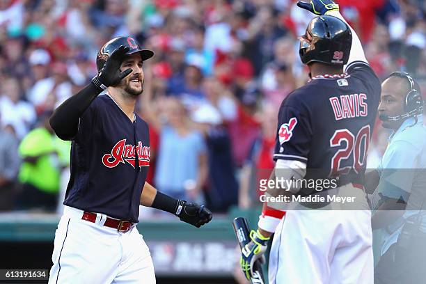 Lonnie Chisenhall of the Cleveland Indians celebrates with Rajai Davis after hitting a three-run home run in the second inning against the Boston Red...