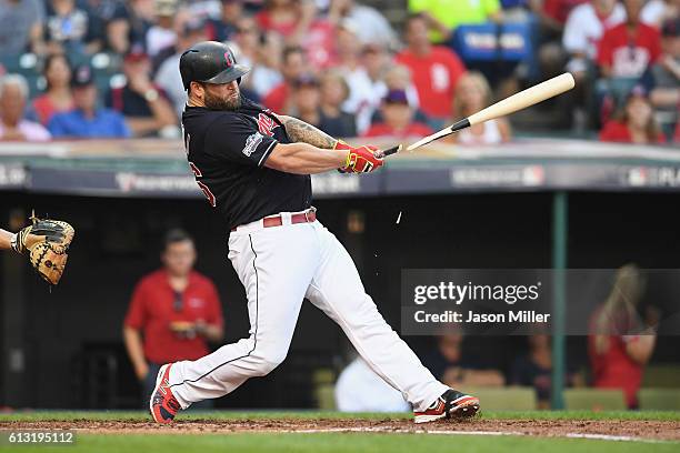 Mike Napoli of the Cleveland Indians breaks his bat as he hits a single in the third inning against the Boston Red Sox during game two of the...