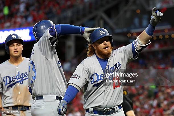 Justin Turner of the Los Angeles Dodgers celebrates with teammate Adrian Gonzalez after hitting a two run home run against the Washington Nationals...