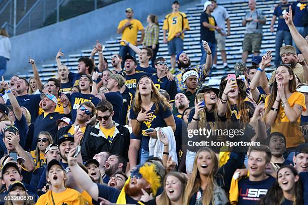 West Virginia Mountaineers fans sing Country Roads during a NCAA football game between the Kansas State Wildcats and the West Virginia Mountaineers...
