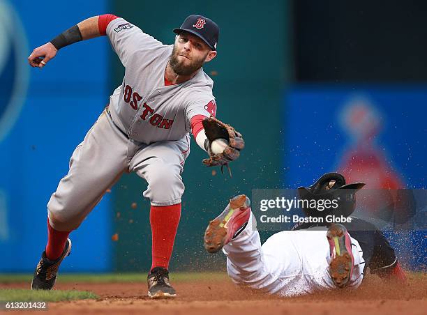 Cleveland Indians infielder Jose Ramirez dives headfirst into second base as Boston Red Sox second baseman Dustin Pedroia is about to tag him while...