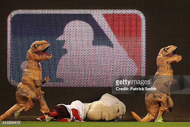 The Presidents Race occurs during a break in play in game one of the National League Division Series at Nationals Park between the Los Angeles...