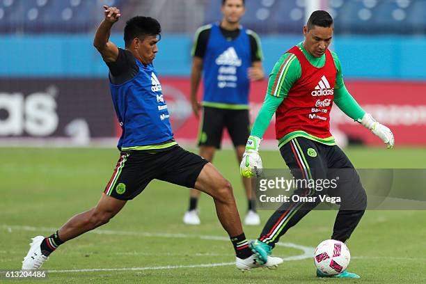 Moises Munoz goalkeeper of Mexico kicks the ball while defended by teammate Jesus Molina during a training session at Nissan Stadium on October 07,...