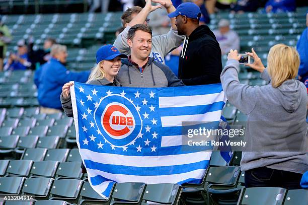 Fans pose for a photo in the stands prior to Game 1 of NLDS between the San Francisco Giants and the Chicago Cubs at Wrigley Field on Friday, October...