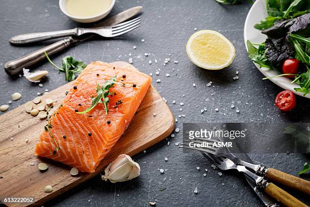 salmon fish on the cutting board - omega stock pictures, royalty-free photos & images