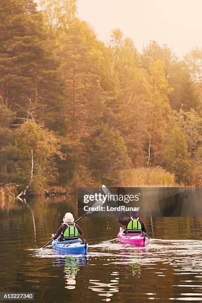 retired couple out kayaking - dalarna stock pictures, royalty-free photos & images