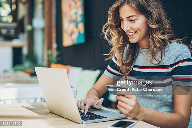 young woman shopping on-line - shopping online stockfoto's en -beelden