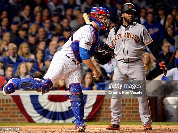 David Ross of the Chicago Cubs picks off Conor Gillaspie of the San Francisco Giants at first base in the first inning during Game 1 of NLDS at...