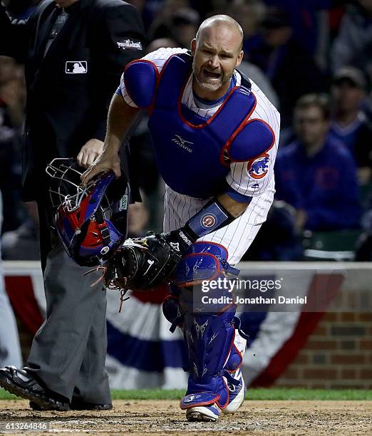 David Ross of the Chicago Cubs reacts after being hit by a pitch in the fifth inning\against the San Francisco Giants\at Wrigley Field on October 7,...