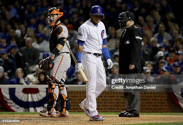 Addison Russell of the Chicago Cubs reacts after striking out in the fifth inning against the San Francisco Giants at Wrigley Field on October 7,...