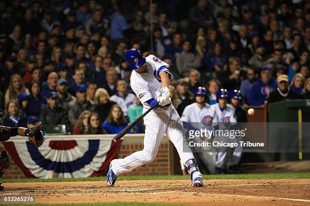 The Chicago Cubs' Kris Bryant doubles in the fourth inning against the San Francisco Giants in Game 1 of the National League Division Series at...