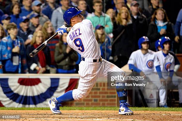 Javier Baez of the Chicago Cubs hits a solo home run in the eighth inning during Game 1 of NLDS against the San Francisco Giants at Wrigley Field on...