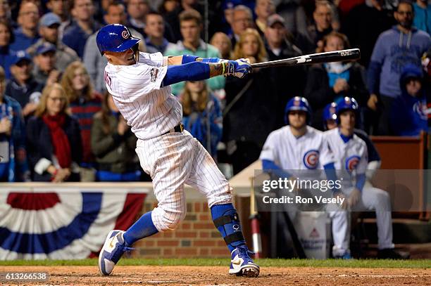 Javier Baez of the Chicago Cubs hits a solo home run in the eighth inning during Game 1 of NLDS against the San Francisco Giants at Wrigley Field on...