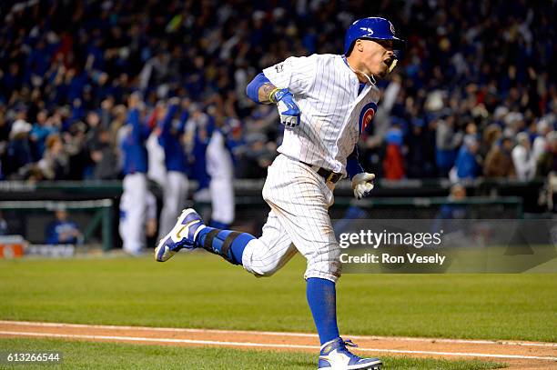 Javier Baez of the Chicago Cubs rounds the bases after hitting a solo home run in the eighth inning during Game 1 of NLDS against the San Francisco...