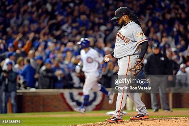 Johnny Cueto of the San Francisco Giants reacts to giving up a solo home run to Javier Baez of the Chicago Cubs in the eighth inning during Game 1 of...