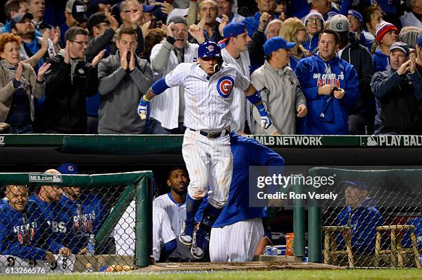 Javier Baez of the Chicago Cubs reacts after hitting a solo home run in the eighth inning during Game 1 of NLDS against the San Francisco Giants at...