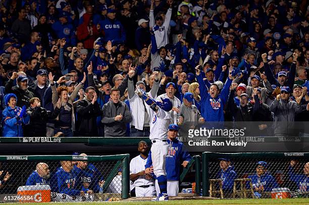 Javier Baez of the Chicago Cubs receives a curtain call after hitting a solo home run in the eighth inning during Game 1 of NLDS against the San...