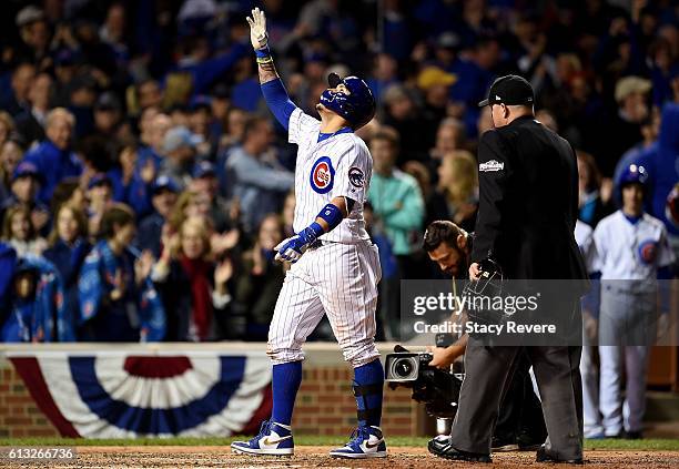 Javier Baez of the Chicago Cubs celebrates after hitting a home run in the eighth inning against the San Francisco Giants at Wrigley Field on October...