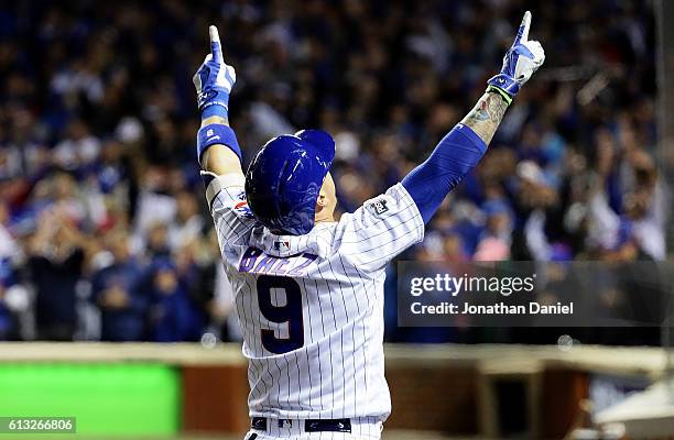 Javier Baez of the Chicago Cubs celebrates after hitting a home run in the eighth inning against the San Francisco Giants at Wrigley Field on October...