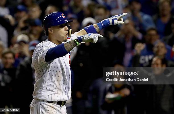 Javier Baez of the Chicago Cubs celebrates after hitting a home run in the eighth inning against the San Francisco Giants at Wrigley Field on October...