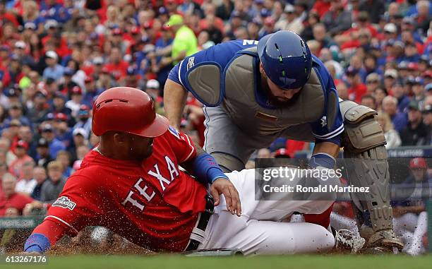 Russell Martin of the Toronto Blue Jays tags out Ian Desmond of the Texas Rangers at home during the seventh inning of game two of the American...