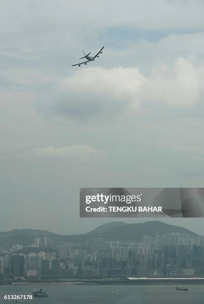 Cathay Pacific Boeing 747-400 aircraft, operating as flight CX8747, flies over Hong Kong's former Kai Tak airport on its final flight over Victoria...