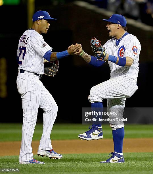 Addison Russell and Javier Baez of the Chicago Cubs celebrate after beating the San Francisco Giants1-0 at Wrigley Field on October 7, 2016 in...