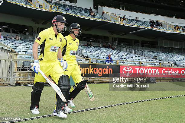 Shaun Marsh and Michael Klinger of the Warriors walk out to open the batting during the Matador BBQs One Day Cup match between Western Australia and...