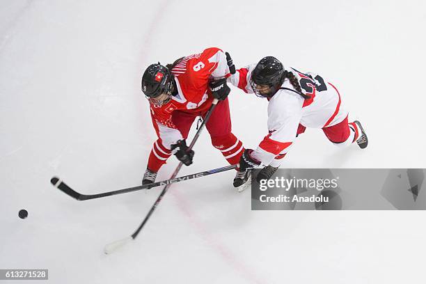 Kwok Hoi Kei of Hong Kong and Betul Kahraman of Turkey in action during a match between Turkey and Hong Kong as part of the IIHF Womens Olympic...