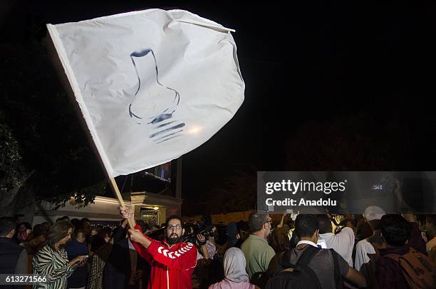 Man holds a placard with the emblem of Justice and Development Party during the Parliamentary elections, in Rabat, Morocco on October 07, 2016.
