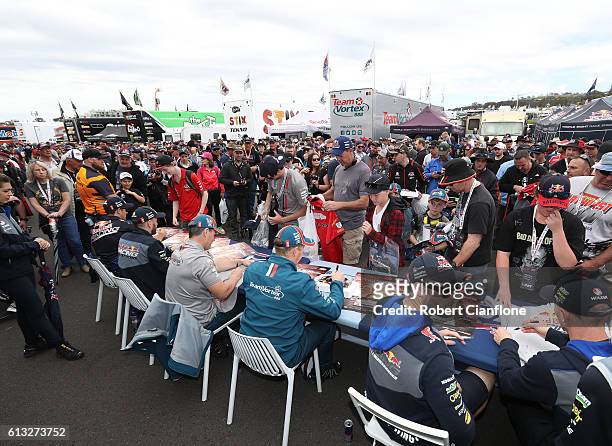 The Triple Eight Team sign autographs at the Bathurst 1000, which is race 21 of the Supercars Championship at Mount Panorama on October 8, 2016 in...