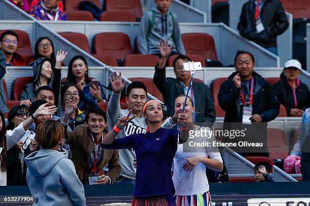 Caroline Garcia and Kristina Mladenovic of France take a selfie with fansafter their victory over Hao-Ching Chan and Yung-Jan Chan of Chinese Taipei...