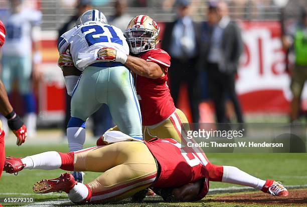 Ezekiel Elliott of the Dallas Cowboys gets tackled by Michael Wilhoite of the San Francisco 49ers during the first half of their NFL football game at...
