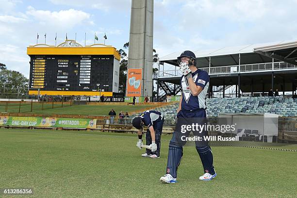 Marcus Harris and Cameron White of the Bushrangers walk out to open the batting during the Matador BBQs One Day Cup match between Western Australia...