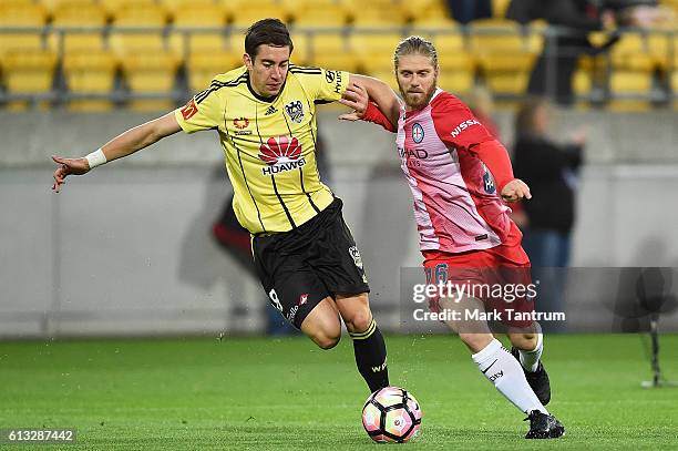 Alex Rodriguez of the Wellington Phoenix and Luke Brattan of Melbourne City compete during the round one A-League match between the Wellington...