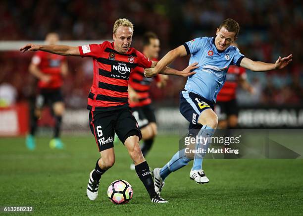 Mitch Nichols of the Wanderers is challenged by Brandon O'Neill of Sydney FC during the round one A-League match between the Western Sydney Wanderers...