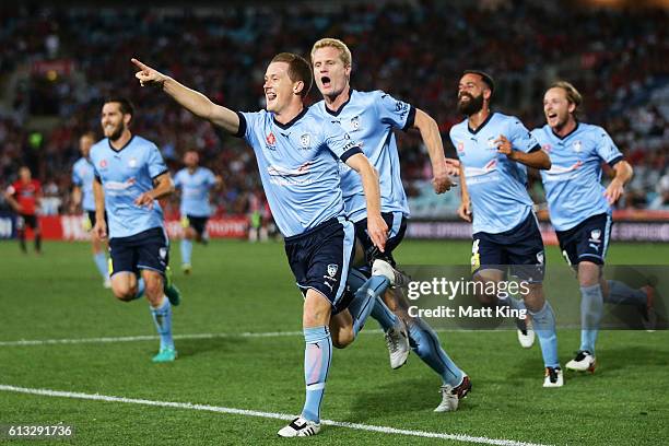 Brandon O'Neill of Sydney FC celebrates with team mates after scoring a goal during the round one A-League match between the Western Sydney Wanderers...