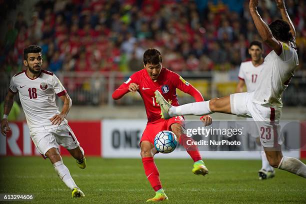 Jung Woo Young of South Korea and Sebastian Soria of Qatar action during an 2018 Russia World Cup Asian Qualifiers South Korea vs Qatar match at...