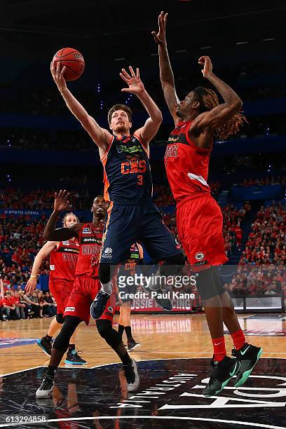 Cameron Gliddon of the Taipans lays up against Jameel McKay of the Wildcats during the round one NBL match between the Perth Wildcats and the Cairns...
